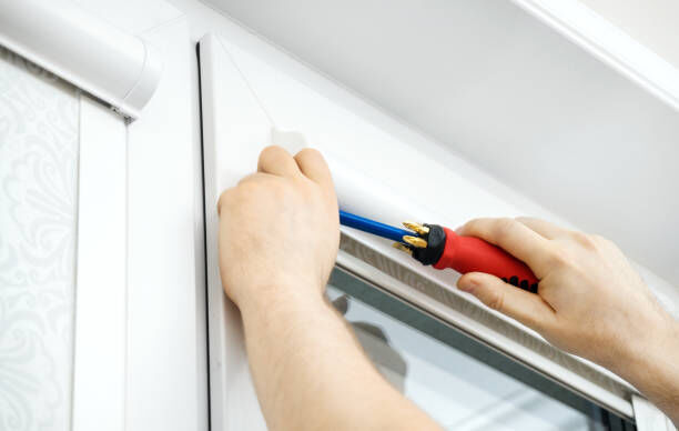 A professional working on blinds.